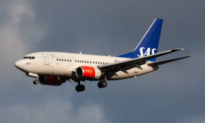 Scandinavian Airlines airliner against a stormy sky