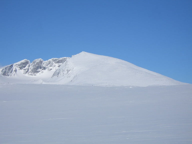 The mountain peaks of snow-covered Snøhetta in central Norway.