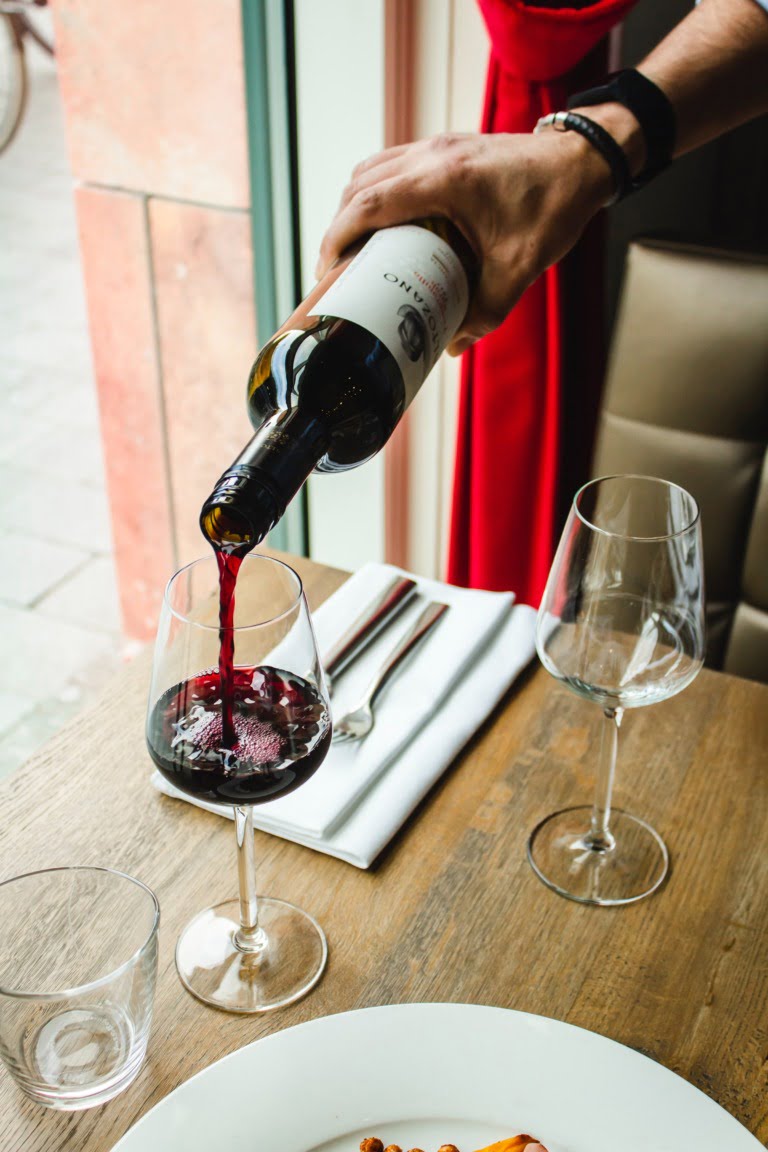 Pouring wine into glasses at home in Norway