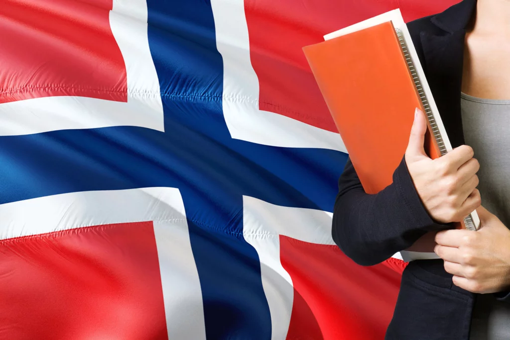 Norwegian language learner in front of a flag
