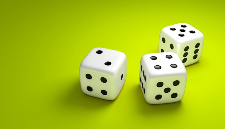 Three dice on a green background