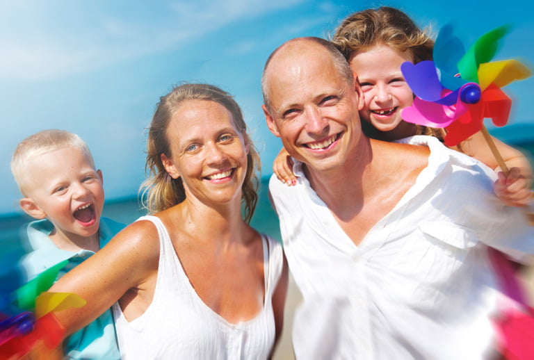 A Scandinavian family portrait with two Swedish parents and two young children.