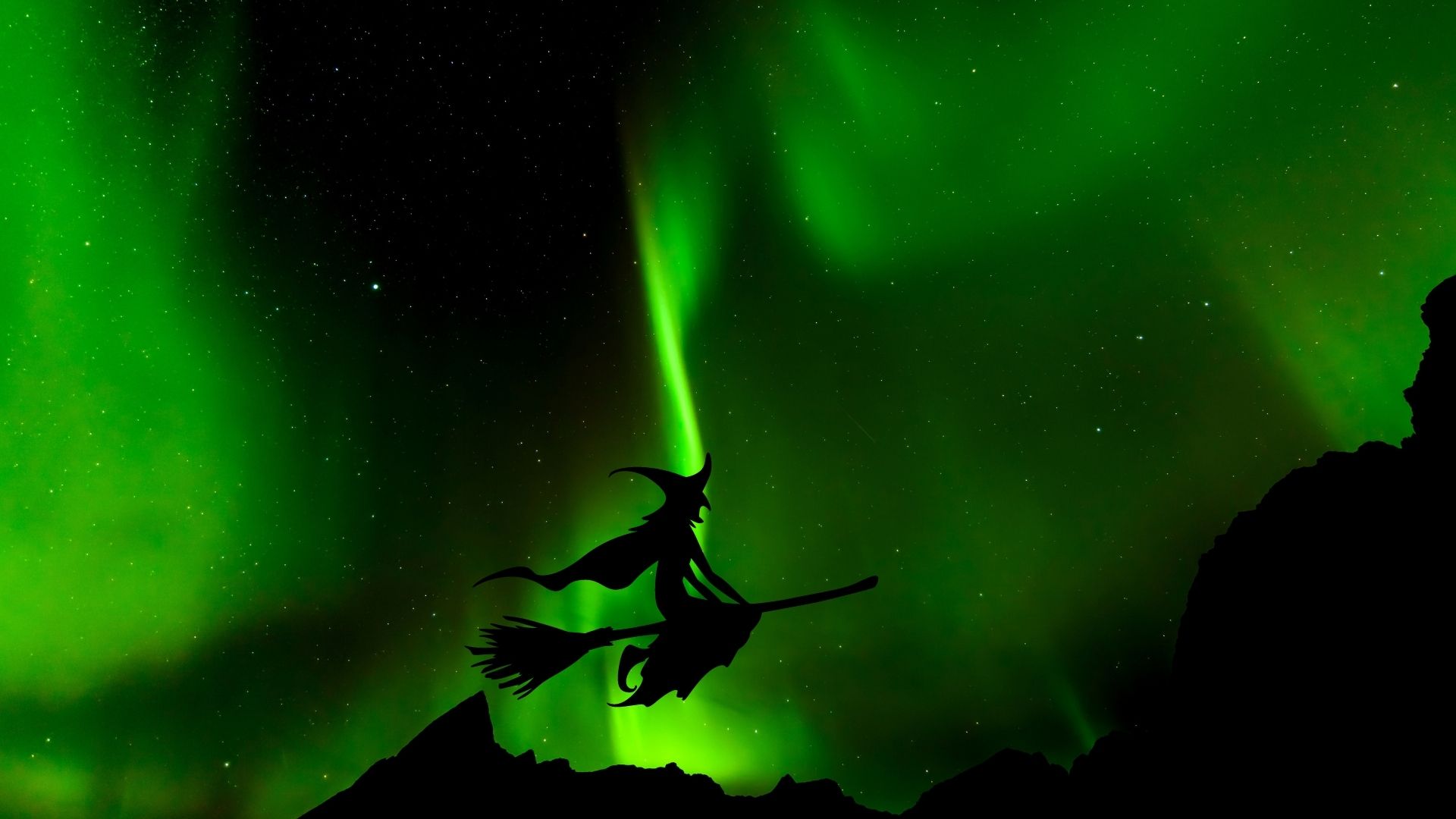 Norwegian witch flying in front of the northern lights in Norway