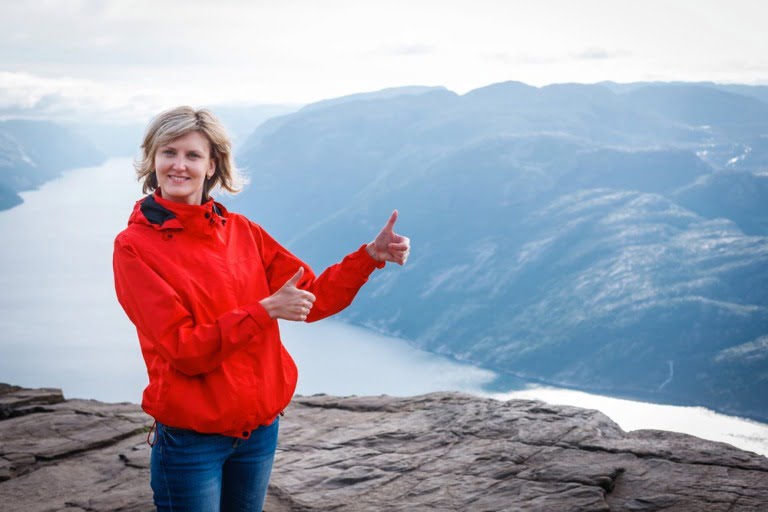 A Norwegian girl in front of a fjord in Norway.