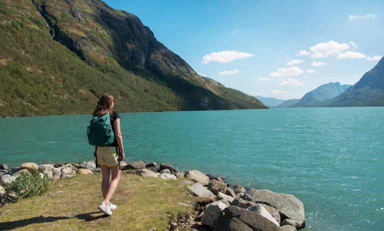 A Norwegian citizen hiking by a fjord