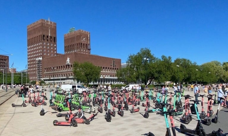 Electric scooters in front of Oslo city hall.