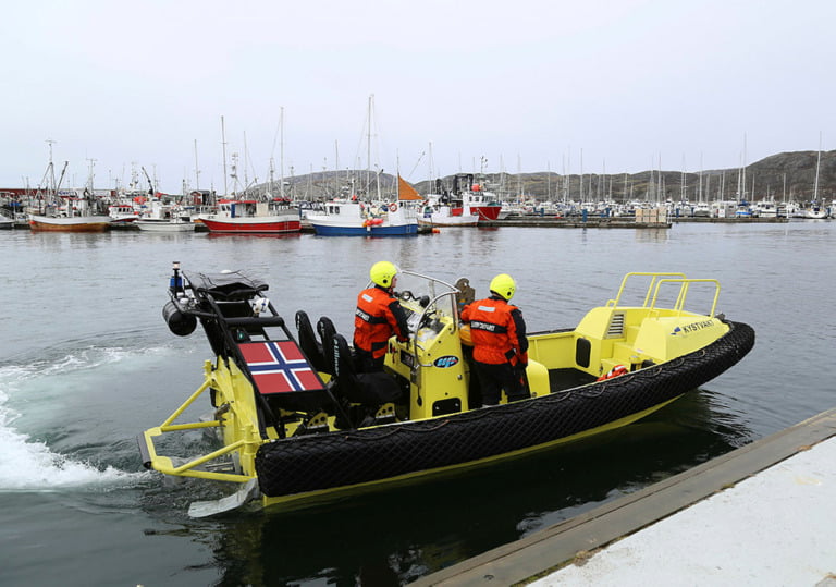 A small boat belonging to the Coast guard vessel KV Senja on its way out from Bodø harbour.