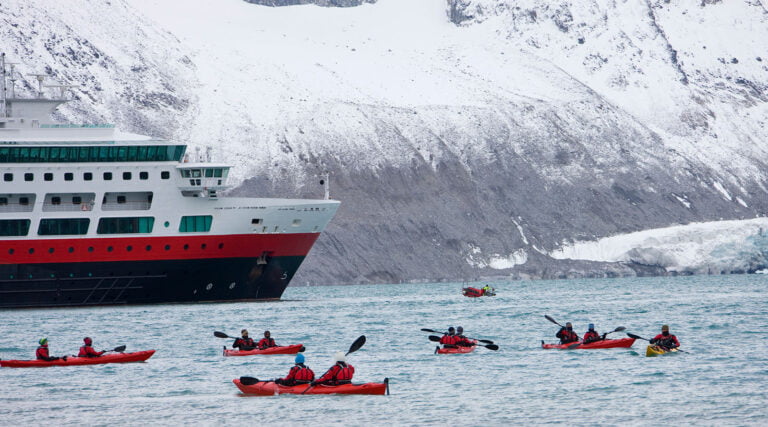 Kayakers from a cruise ship in the waters of Svalbard