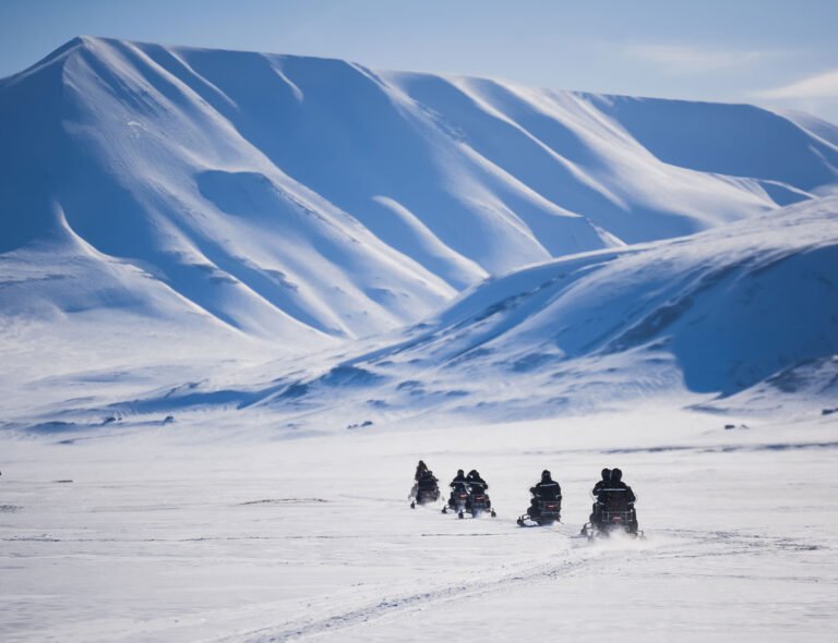 Snow scooter tourists on Svalbard