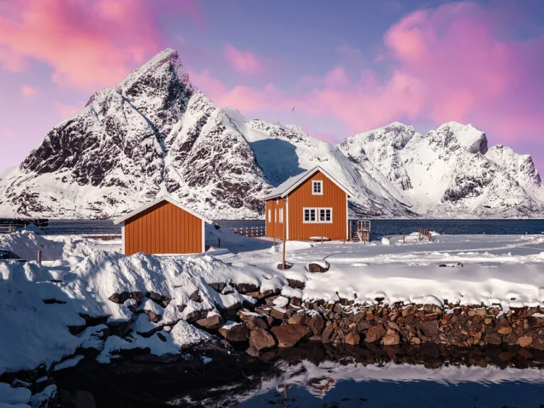 Yellow cabins and a pink sky in a Lofoten winter