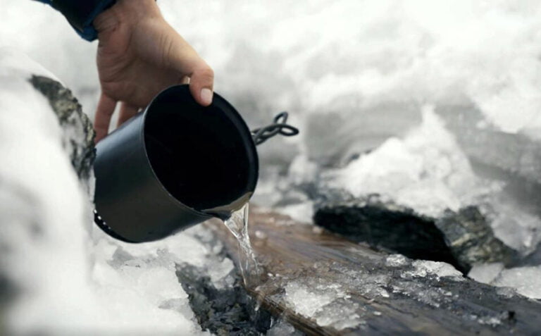 Melting ice from the ski with warmed water