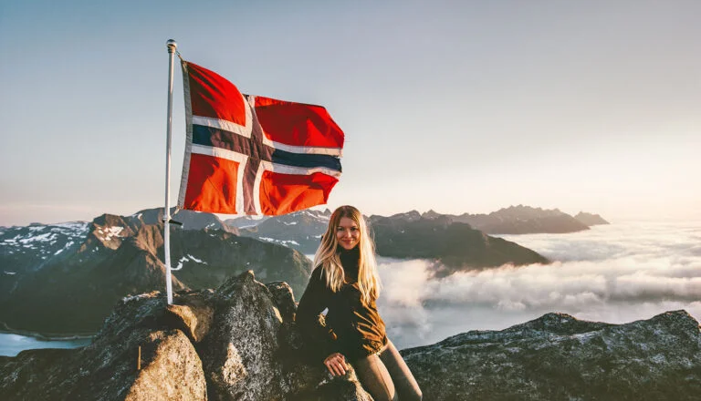 Norwegian female hiker with the flag of Norway