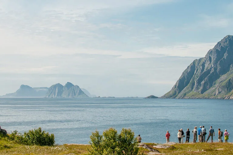 A group of tourists at the end of the Lofoten islands