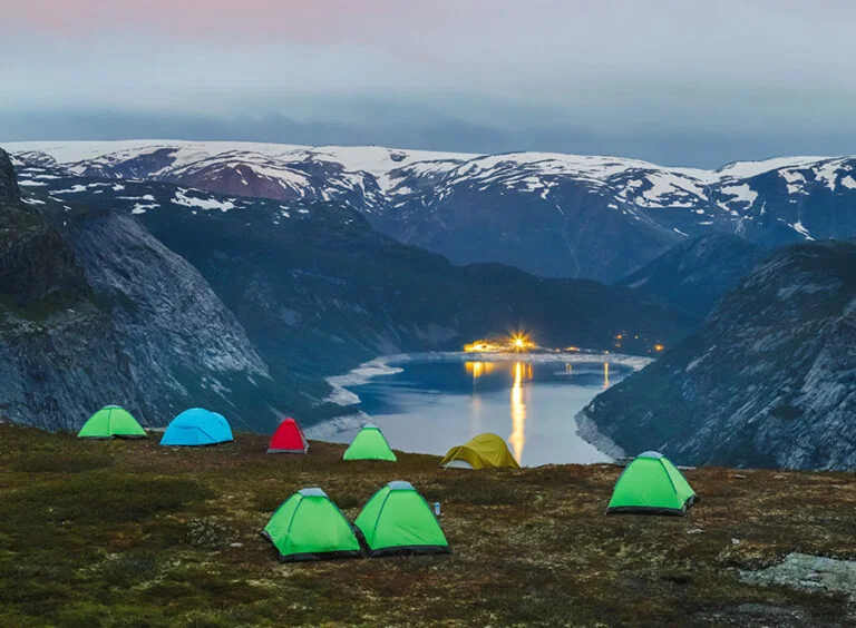 Campsite at the edge of cliff overlooking Ringedalsvatnet lake on the Trolltunga hiking trail in Norway.