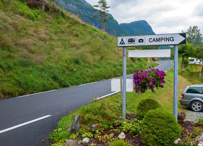 Campsite signpost on a road in Norway.