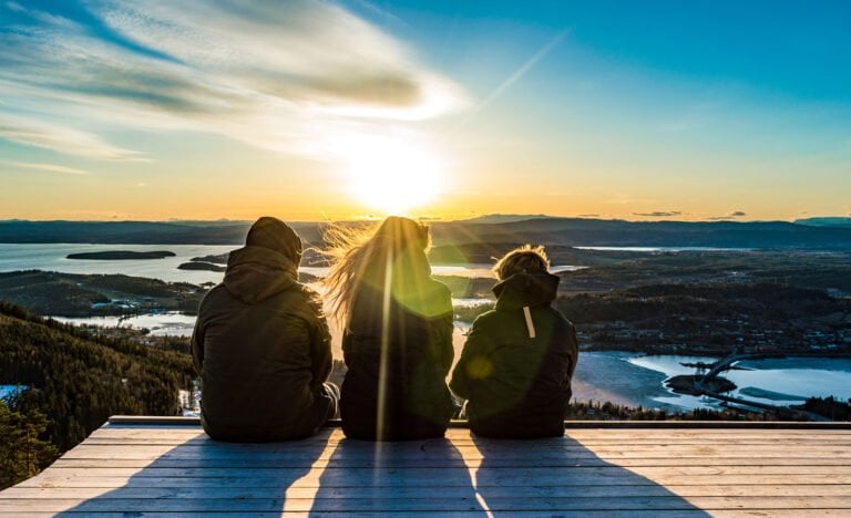 A young family at a viewpoint in Norway.