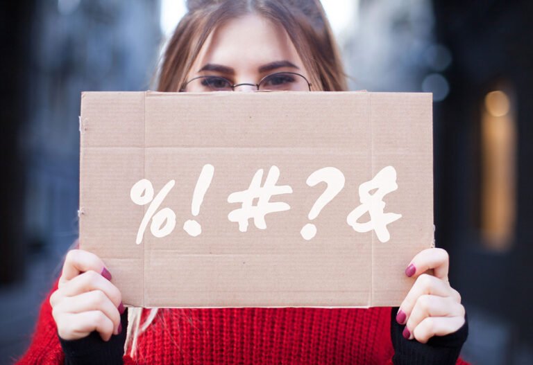 Norwegian woman holding a curse word sign.