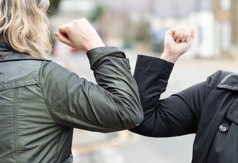 A pandemic-friendly elbow handshake.