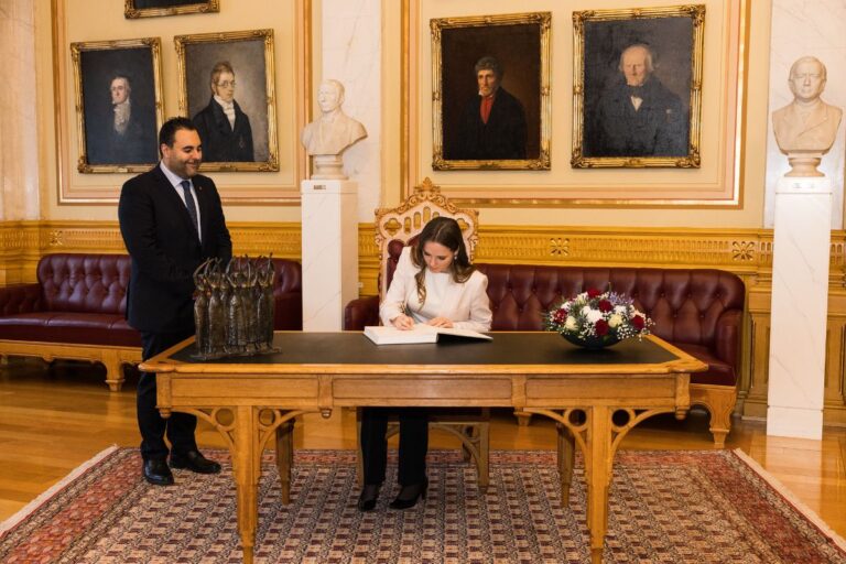 Princess Ingrid Alexandra of Norway signs the guestbook at the Norwegian Parliament.