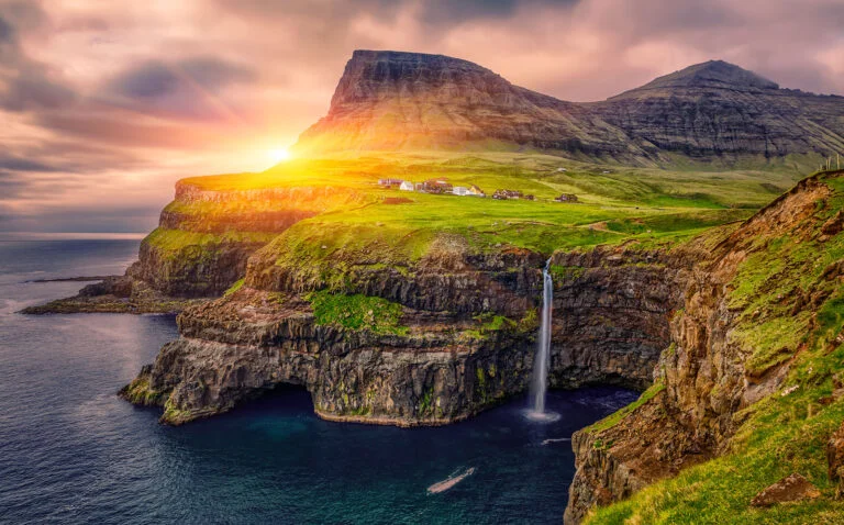 Gasadalur village and beautiful waterfall, At Sunset, Vagar, Faroe Islands, Denmark.