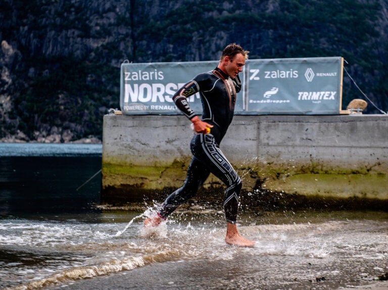 A competitor emerges from Norway's Hardangerfjord in the Norseman Xtreme triathlon. Photo: Kai-Otto Melau.
