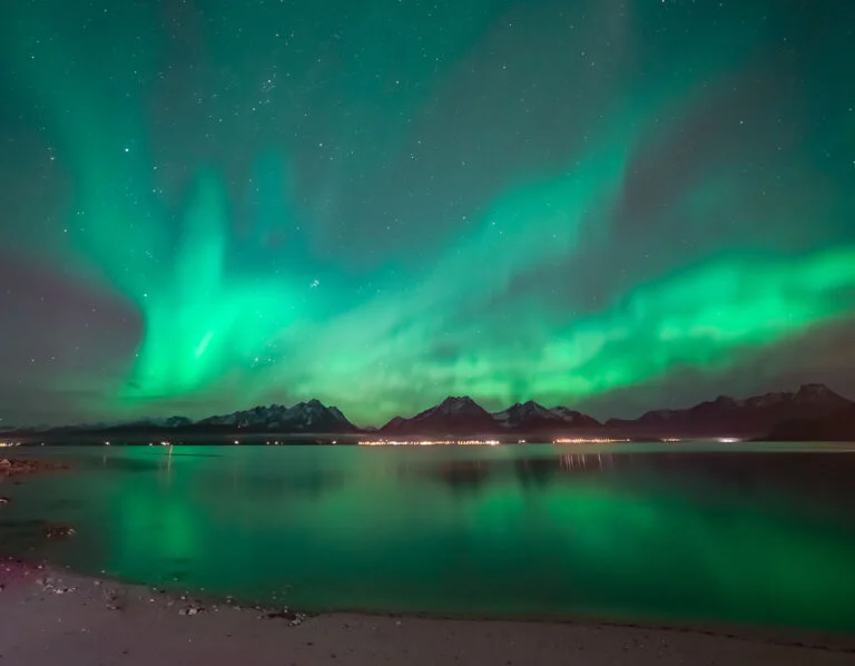 Lyngen Alps in Troms county with an aurora borealis display.