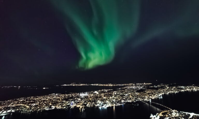 Northern lights above Tromsø city centre in Northern Norway.
