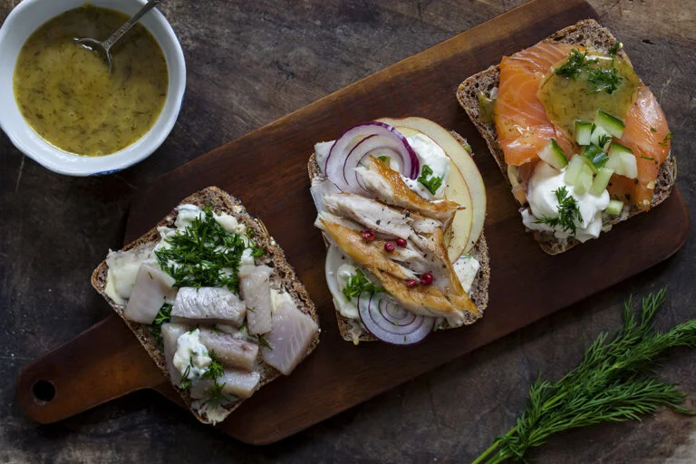A platter of Scandinavian open sandwiches featuring herring, mackerel and salmon.