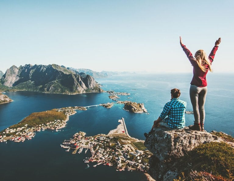 Hikers praising the Lofoten Islands in northern Norway