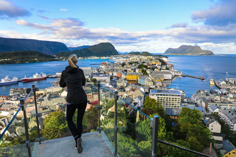 A tall Norwegian woman looking out over Ålesund, Norway.