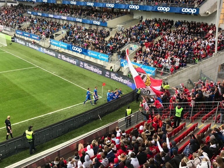 A small group of Tromso fans celebrate a goal against Rosenborg at Lerkendal Stadium in Trondheim.