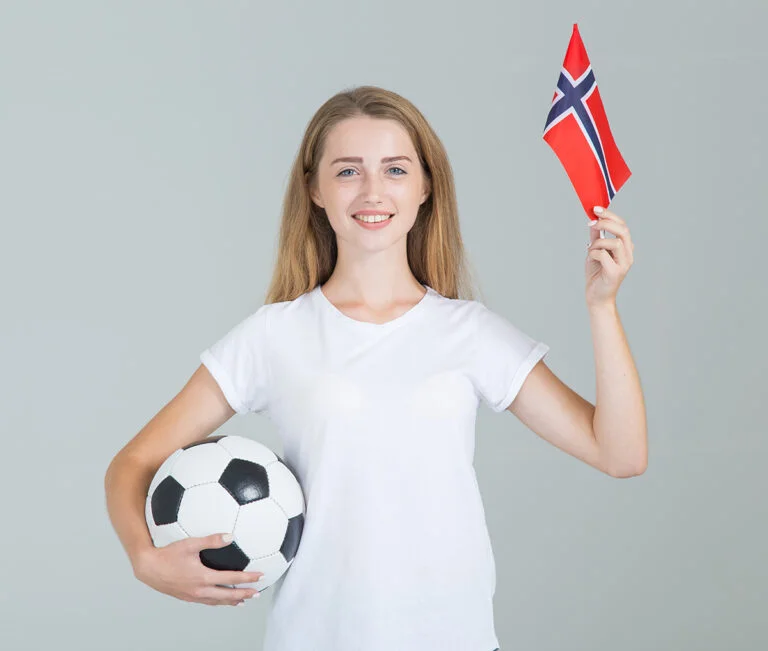 Norwegian woman footballer with flag of Norway.