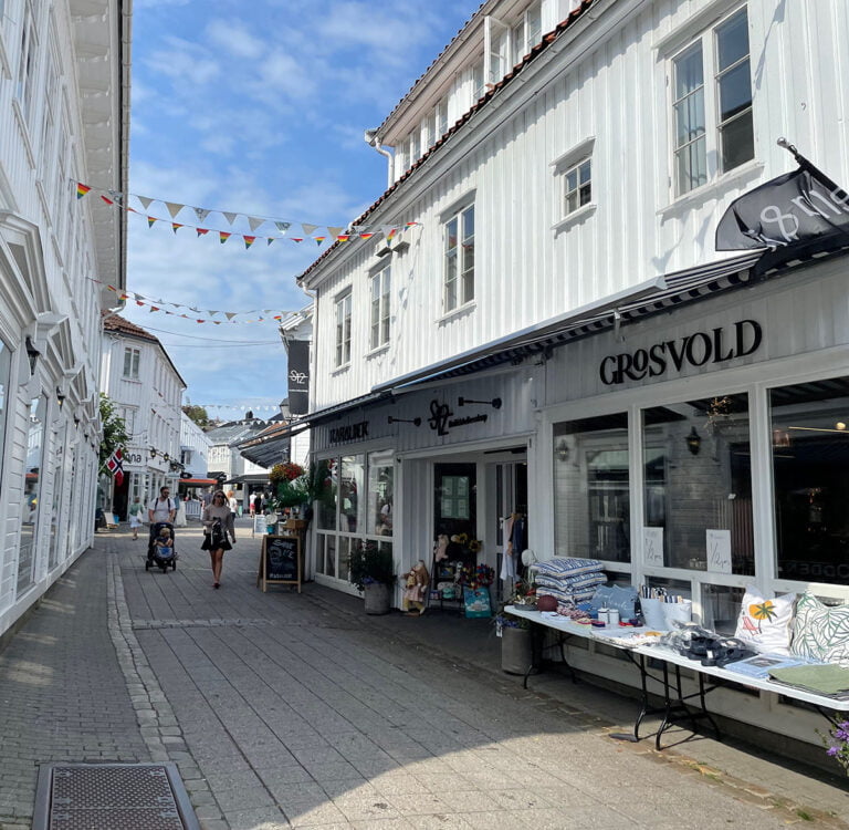 White, wooden buildings in Grimstad town centre.