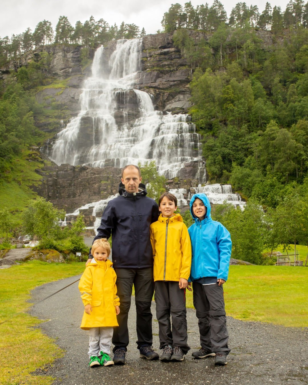 Family at Tvinnefossen waterfall in Norway.