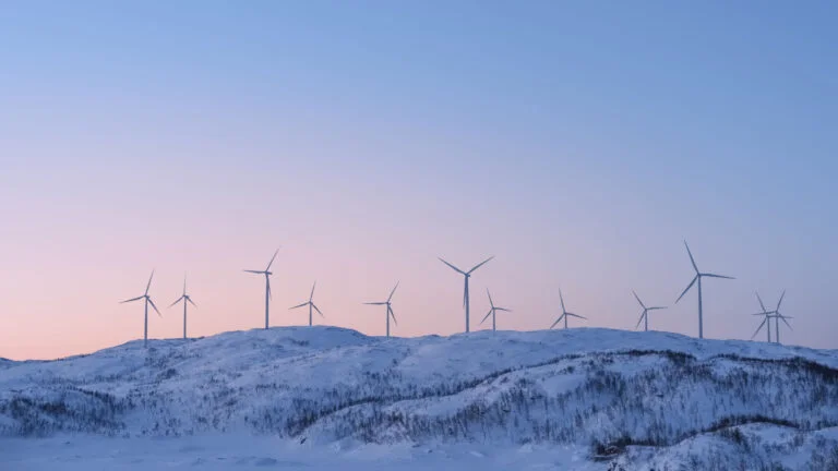 Norway wind farm on snowy mountain.