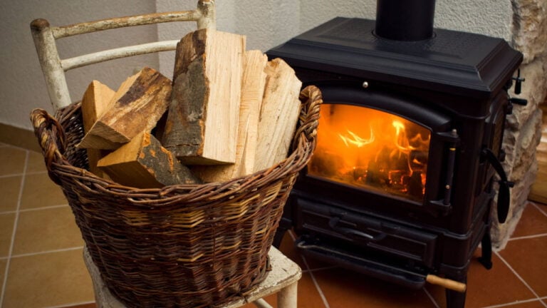 Basket of wood and a wood burning oven.