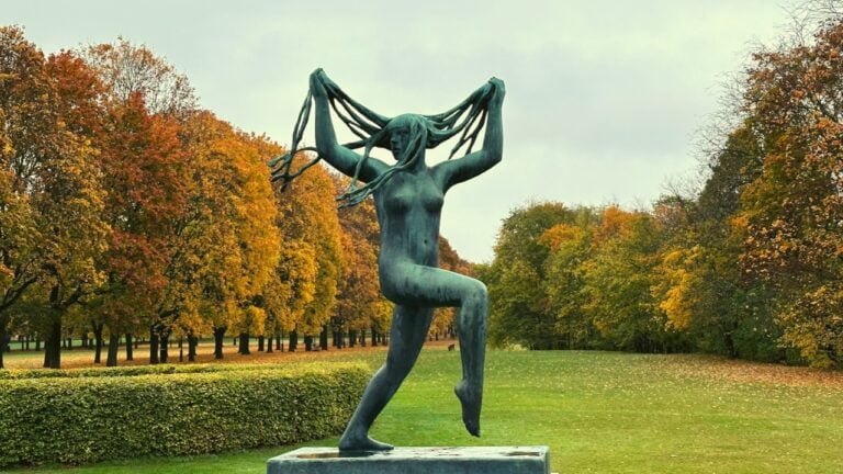Famous Gustav Vigeland sculpture with an autumnal backdrop.