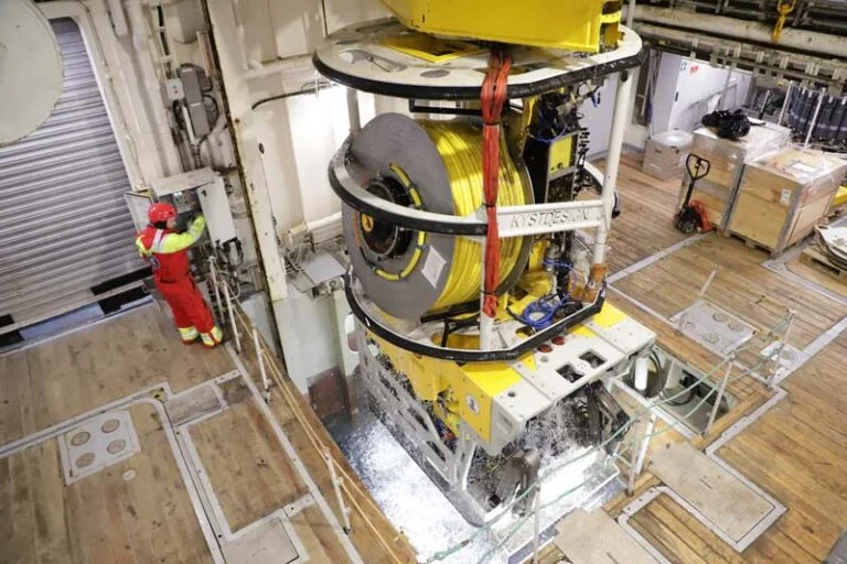 ROV emerges through the moonpool, dripping with ice cold Arctic water after one of its dives.