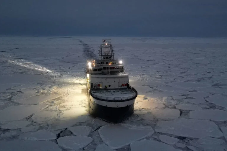 The Kronprins Haakon breaks ice by sliding on top of it and crushing it under its enormous weight. The ice on the picture is already somewhat broken up. Sometimes the ship needs to advance through a continuous sheet of thick ice.
