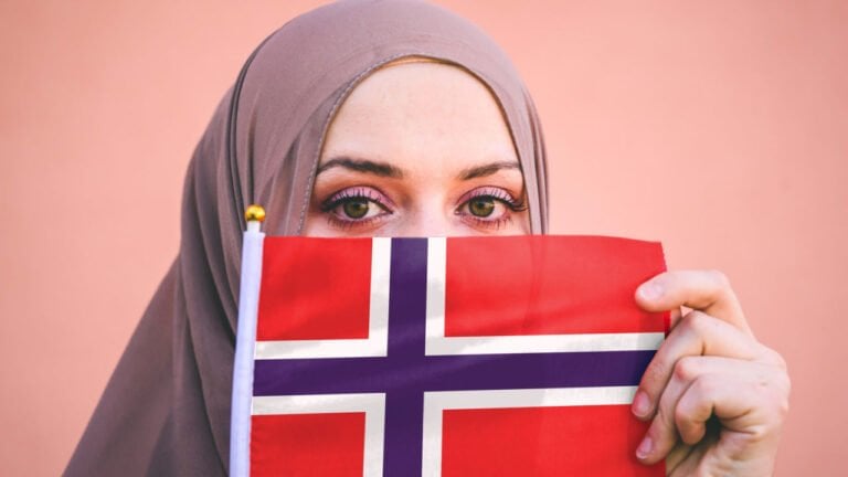 Muslim woman with a flag of Norway.