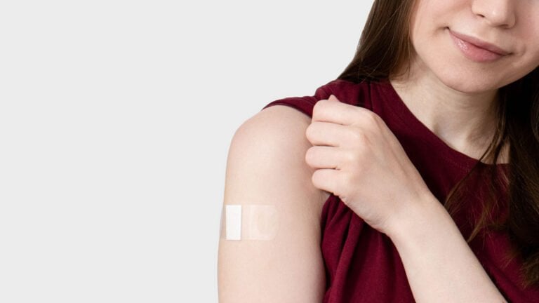Person with flu jab plaster