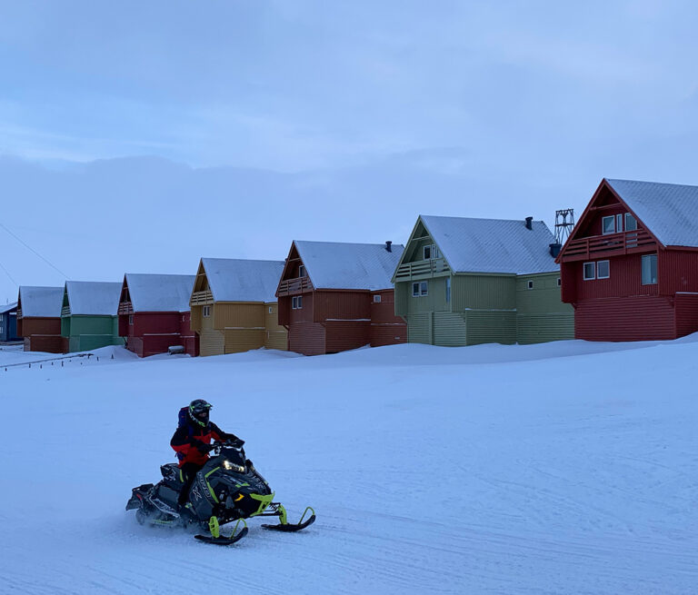 A local on a snowmobile in Longyearbyen.