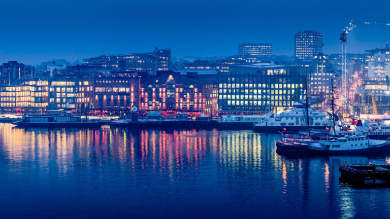 Aker Brygge offices in Oslo in twilight.