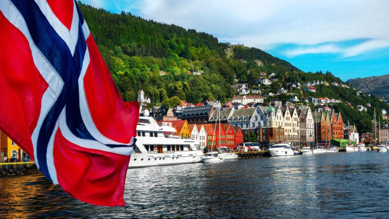 A view of Bergen’s Bryggen with a flag of Norway.