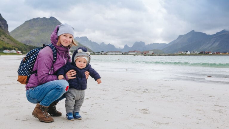 Mother and baby boy on a Norway beach.