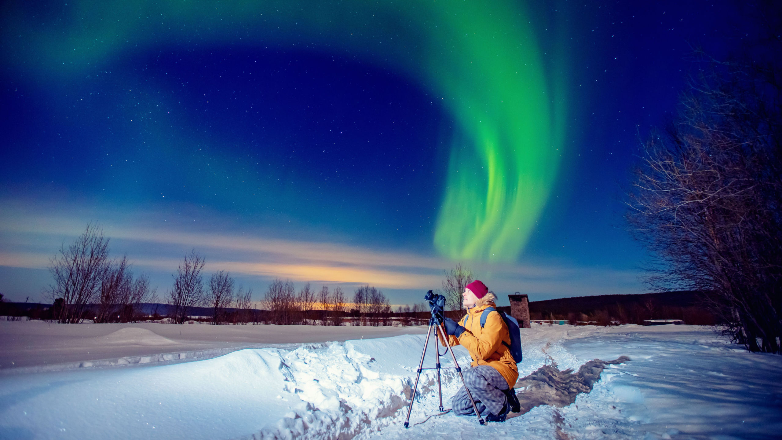 Northern lights photographer in full outdoor gear.