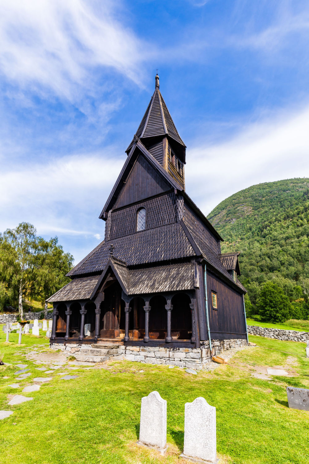 Tall image of Urnes Stave Church in fjord Norway.