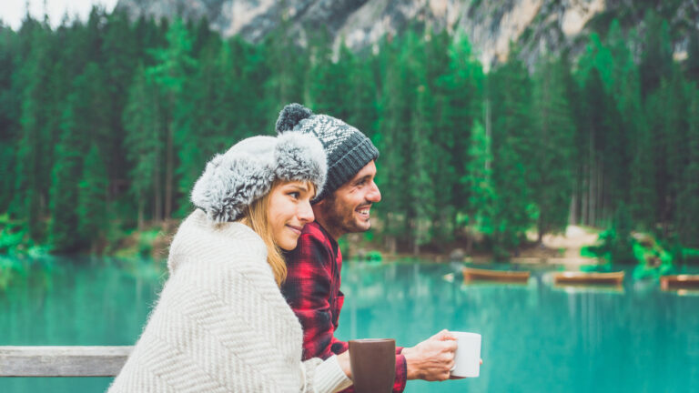 Happy people in Finland drinking coffee by a lake.