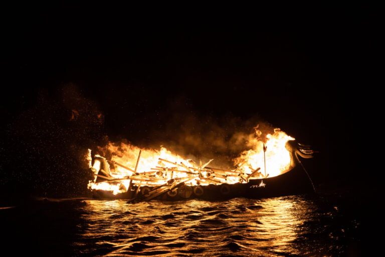 Viking ship in flames image.