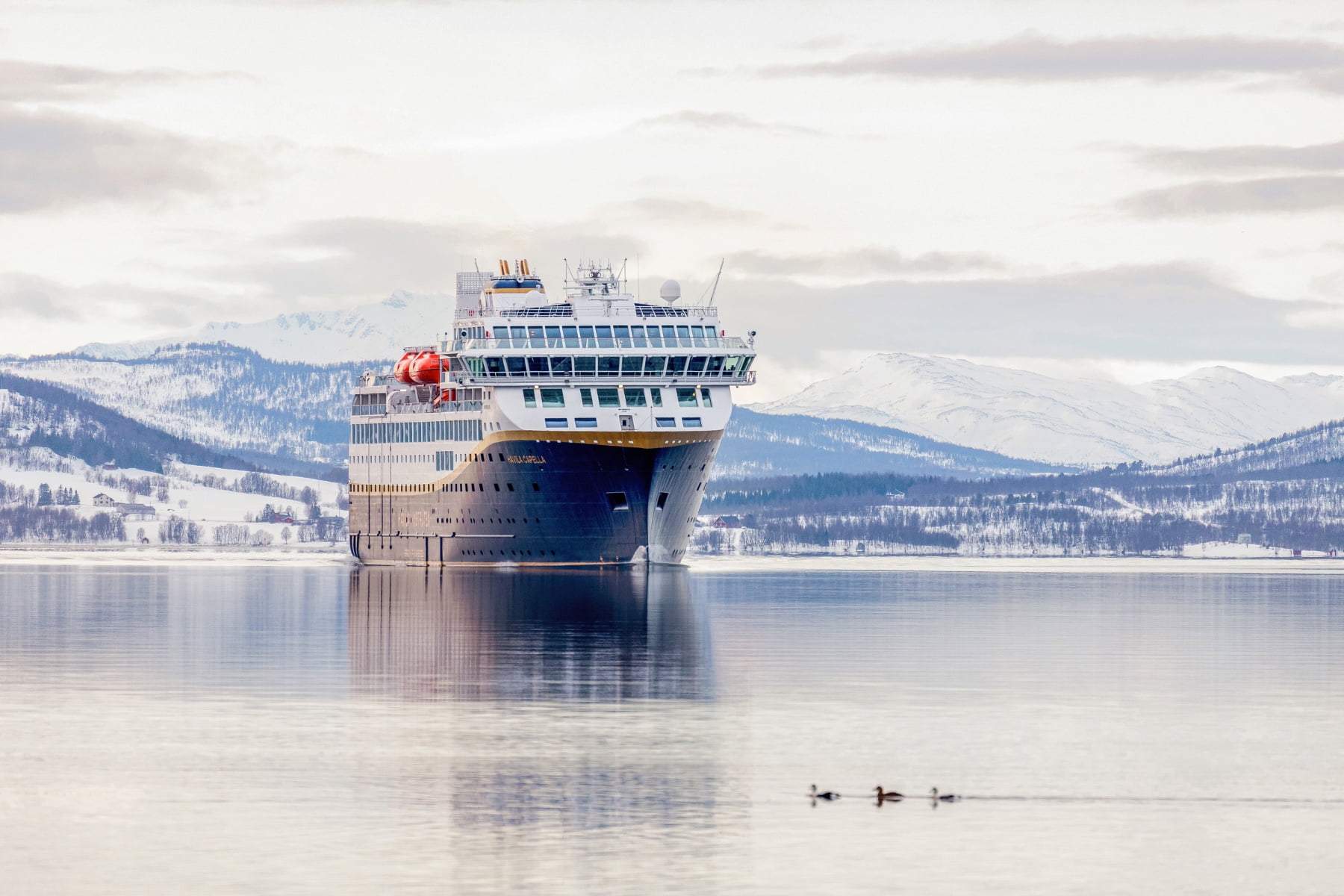 Havila Voyages vessel on the Norwegian coastline.